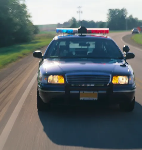 Motion shot of police car driving on road