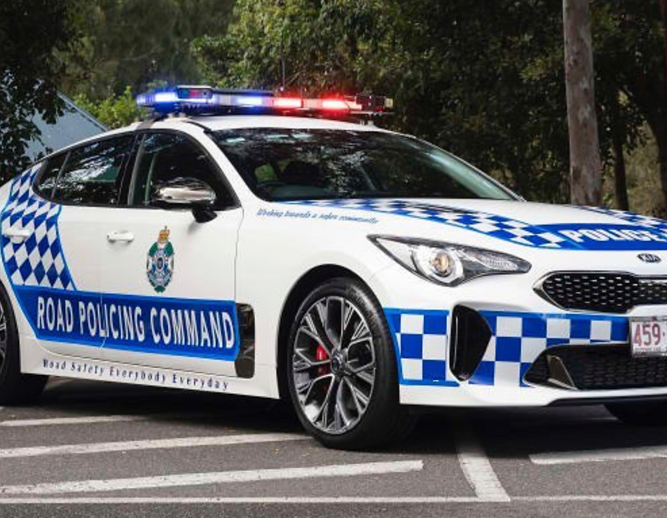Australian police car with lights flashing and the words 'Road Policing Command'