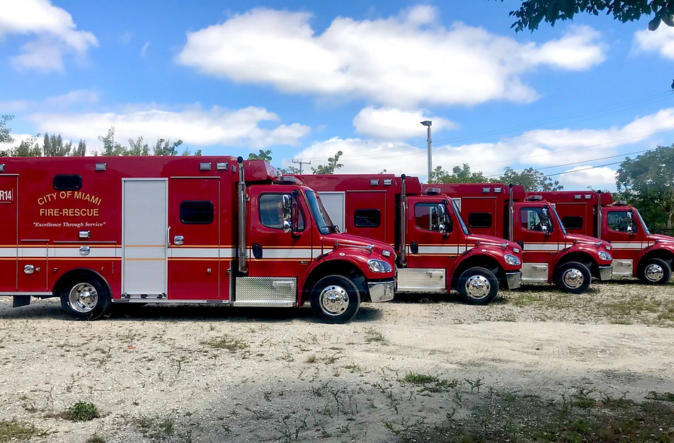 Four rescue vehicles with City of Miami Fire-Rescue 'Excellence Through Service' on the side